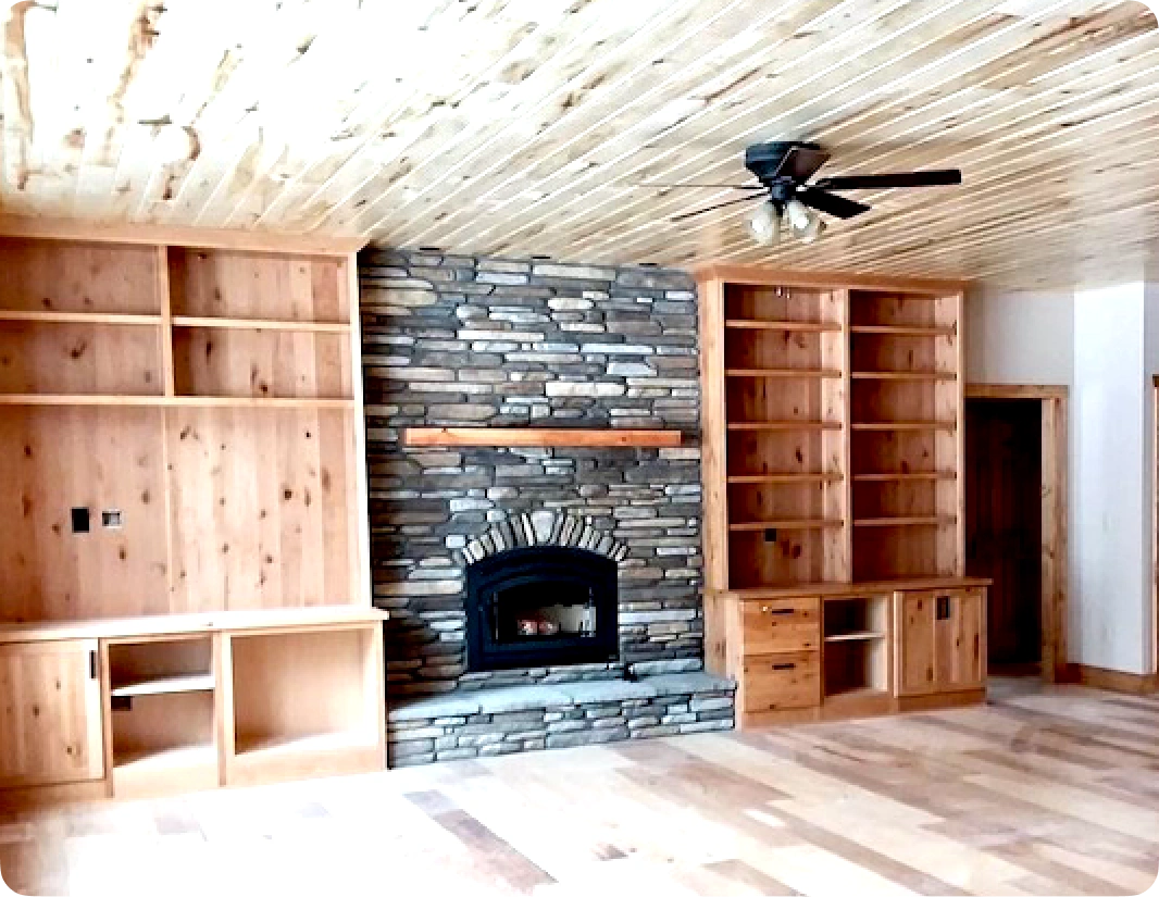 A room with a fireplace and shelves in it