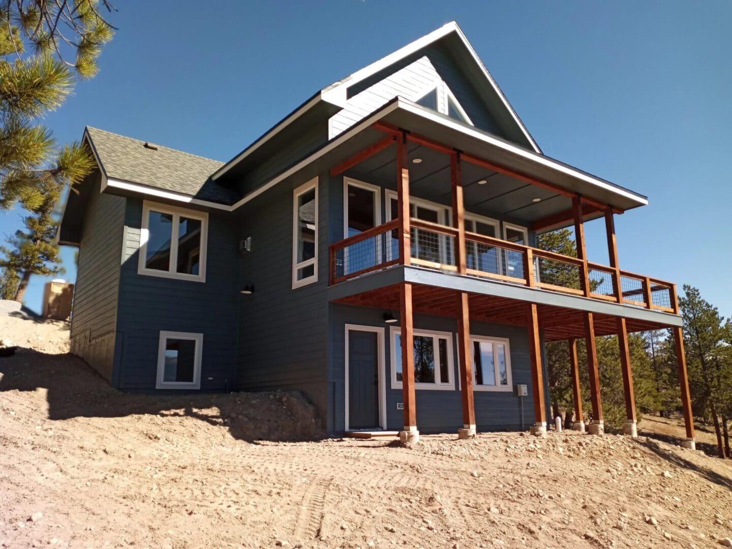 A house with a porch and a deck on the side.