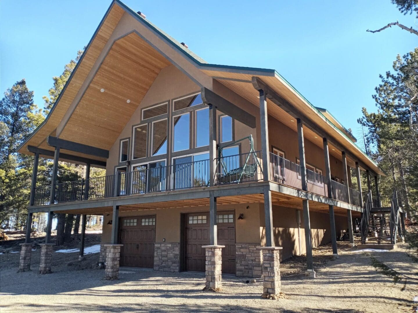 A large house with a balcony and a stone wall.