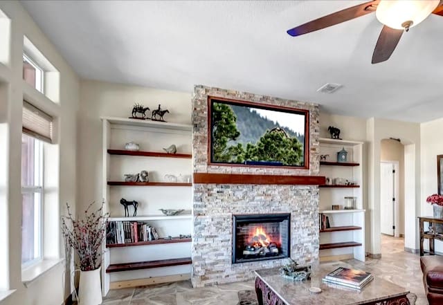 A living room with a fireplace and a flat screen tv.