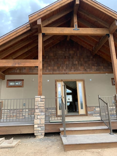 A large porch with steps leading to the front door.