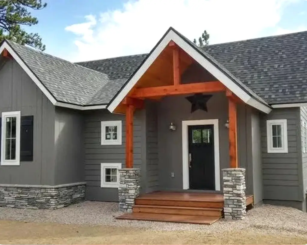 A house with a porch and steps leading to the front door.