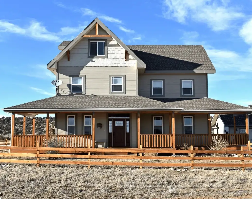 A large house with a wooden fence around it.